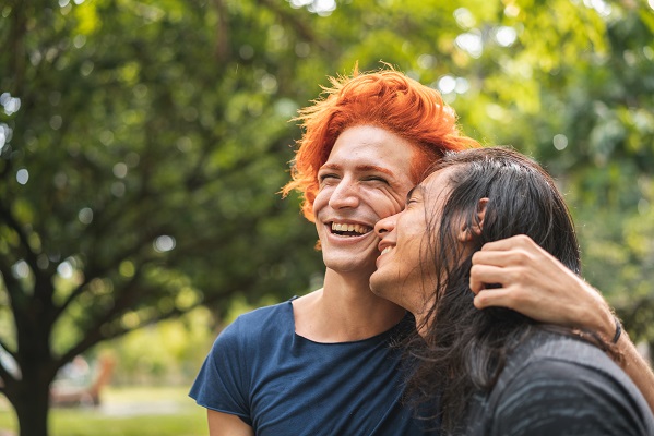 A couple outside laughing.