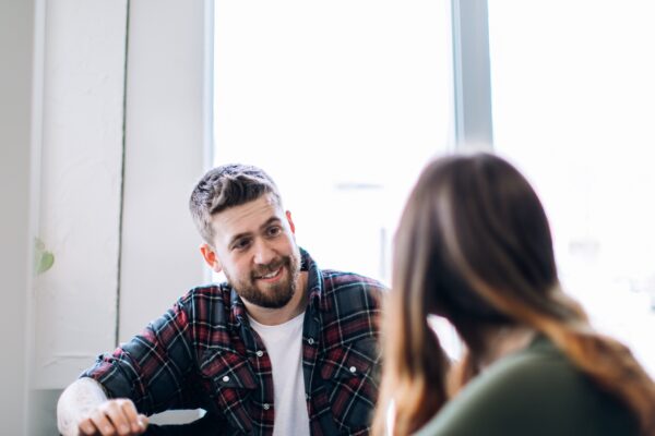 A man talking to another person.